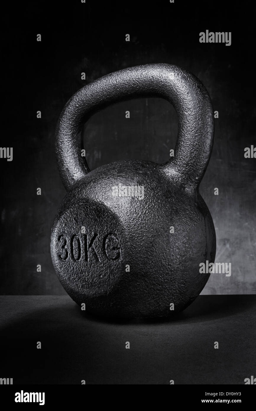 A rough and tough heavy 30 kg 66 lbs cast iron kettlebell Stock Photo Alamy