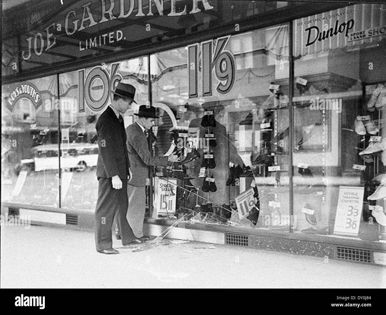 Shop window of Joe Gardiner's Shoe Store smashed in George Street, Sydney, c. 1934, by Sam Hood Stock Photo
