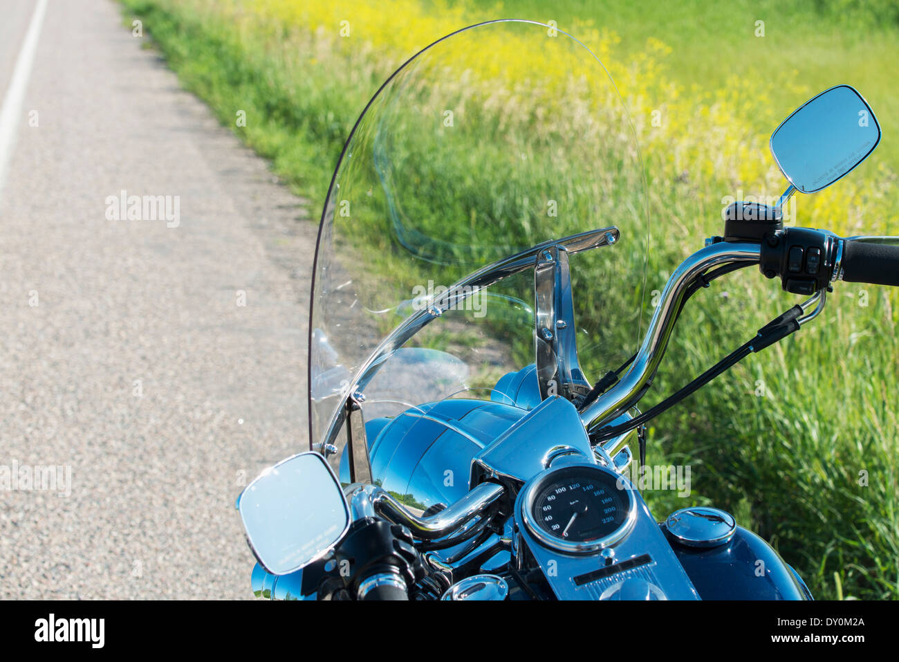 A shiny dashboard on a motorcycle parked at the side of the road; East Selkirk, Manitoba, Canada Stock Photo