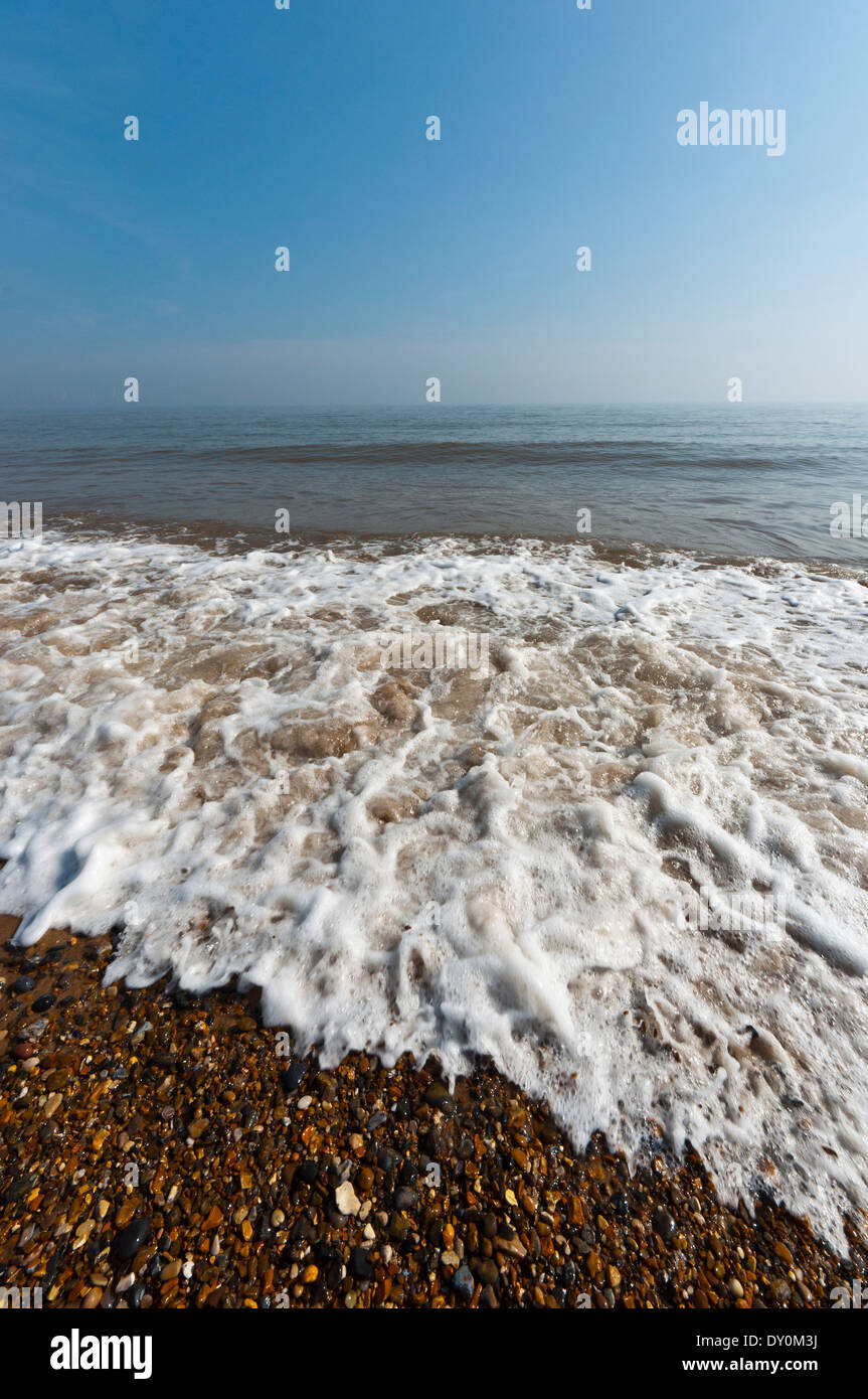 Waves lapping on shingle beach Stock Photo