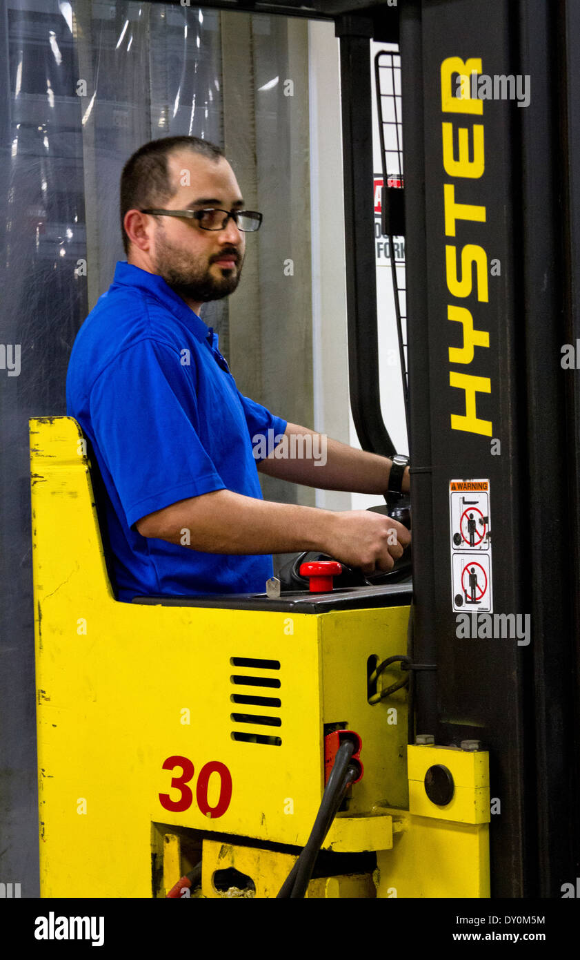 employee working on forklift inside computer technology warehouse Stock Photo Alamy