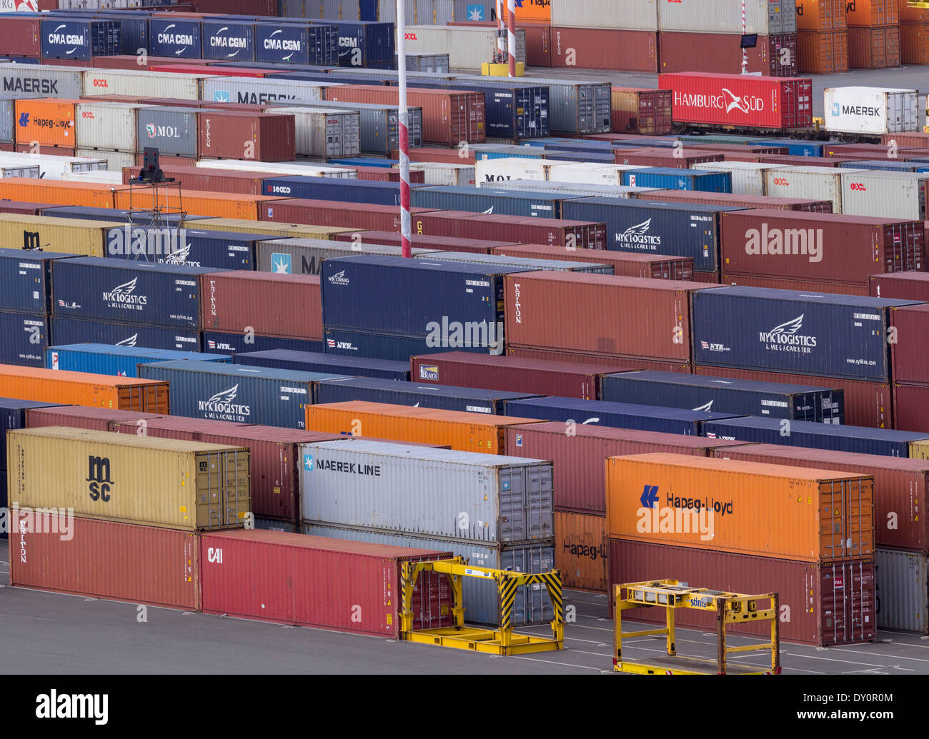 Stacks of industrial shipping containers by a wharf at a port Stock Photo