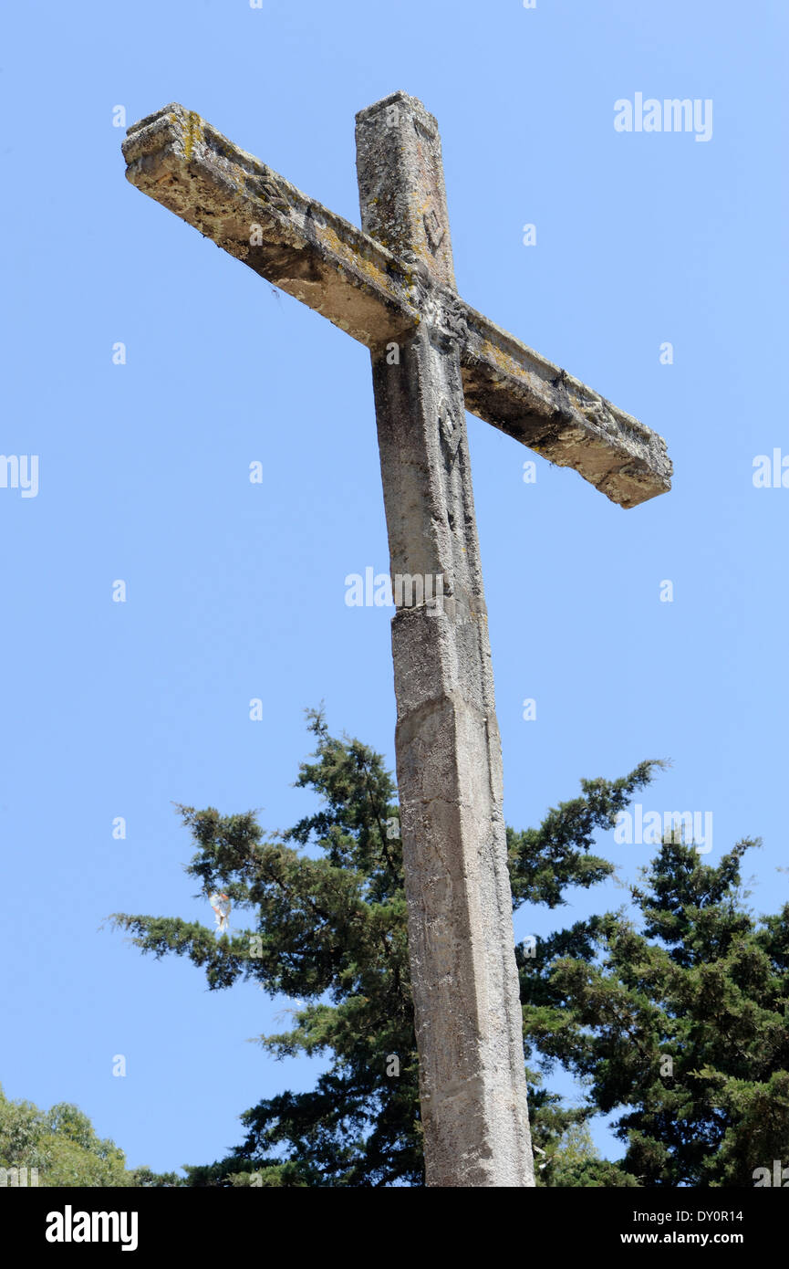 Stone cross at the top of Cerro de la Cruz above Antigua.  Antigua Guatemala, Republic of Guatemala. Stock Photo