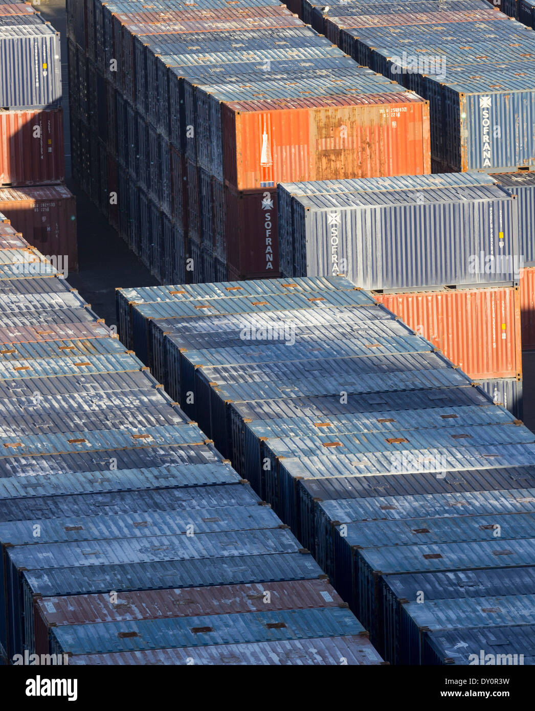 Stacks of industrial shipping containers at a port Stock Photo