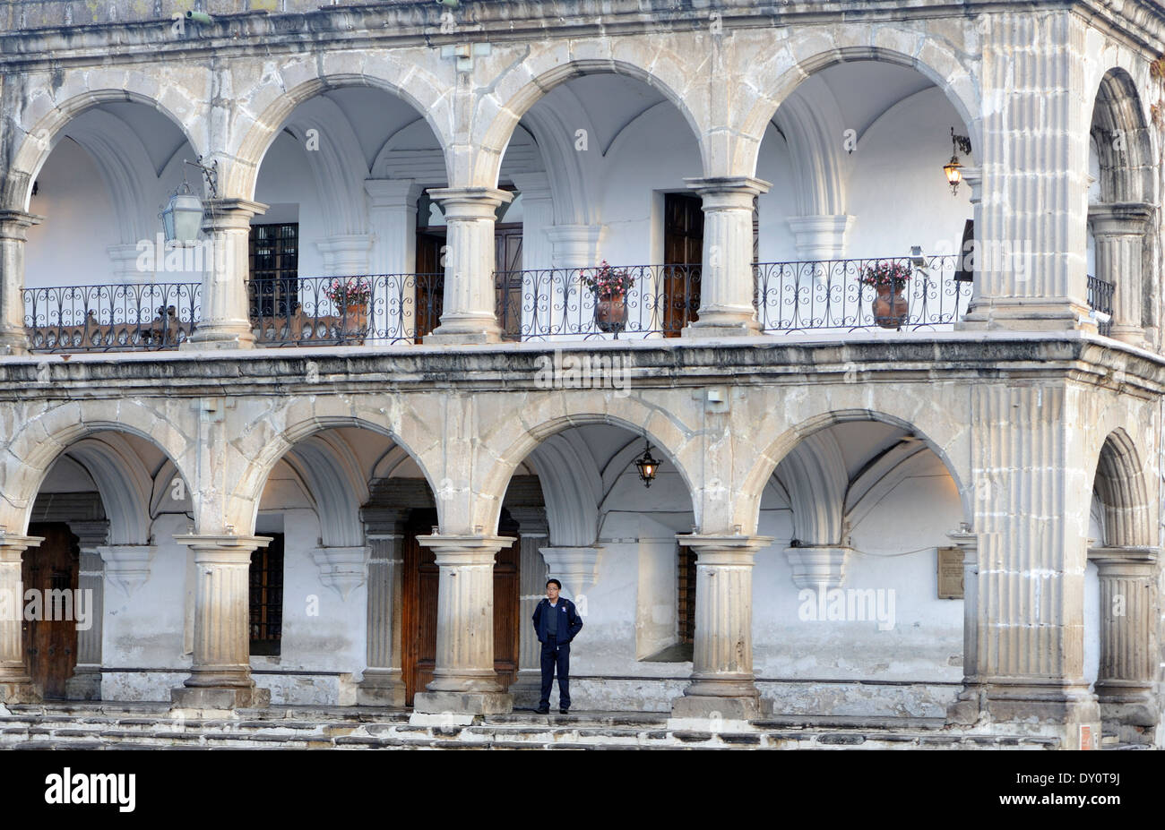 The robust stone colonnades of the 18th century El Ayuntamiento, the town hall, building on the north side of Parque Central. Stock Photo