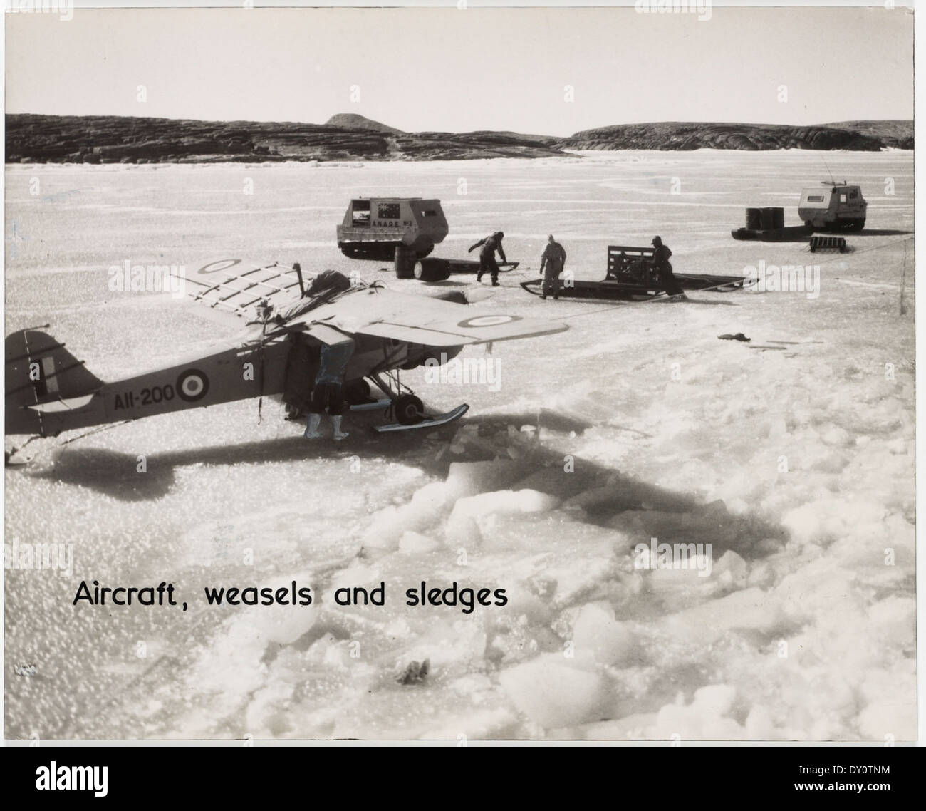 Auster aircraft fitted with skis, weasels and sledges on the fast ice near the Mawson Station in Antarctica Stock Photo