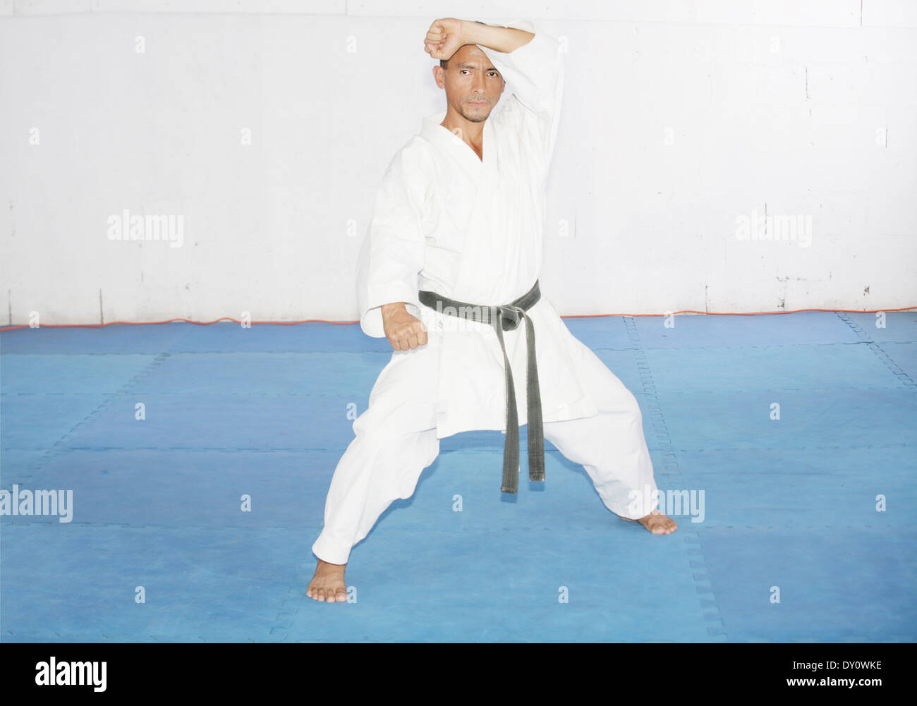 Black belt karate man in defending position Stock Photo