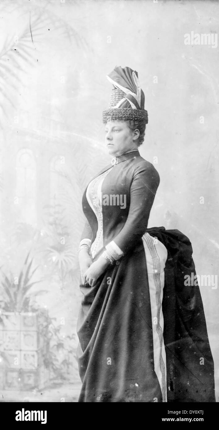 Mrs Hughes, in cuirass bodice suit with shelf bustle and flower pot hat, ca. 1887 / extra large format wet plate glass negative by Freeman & Co. Stock Photo