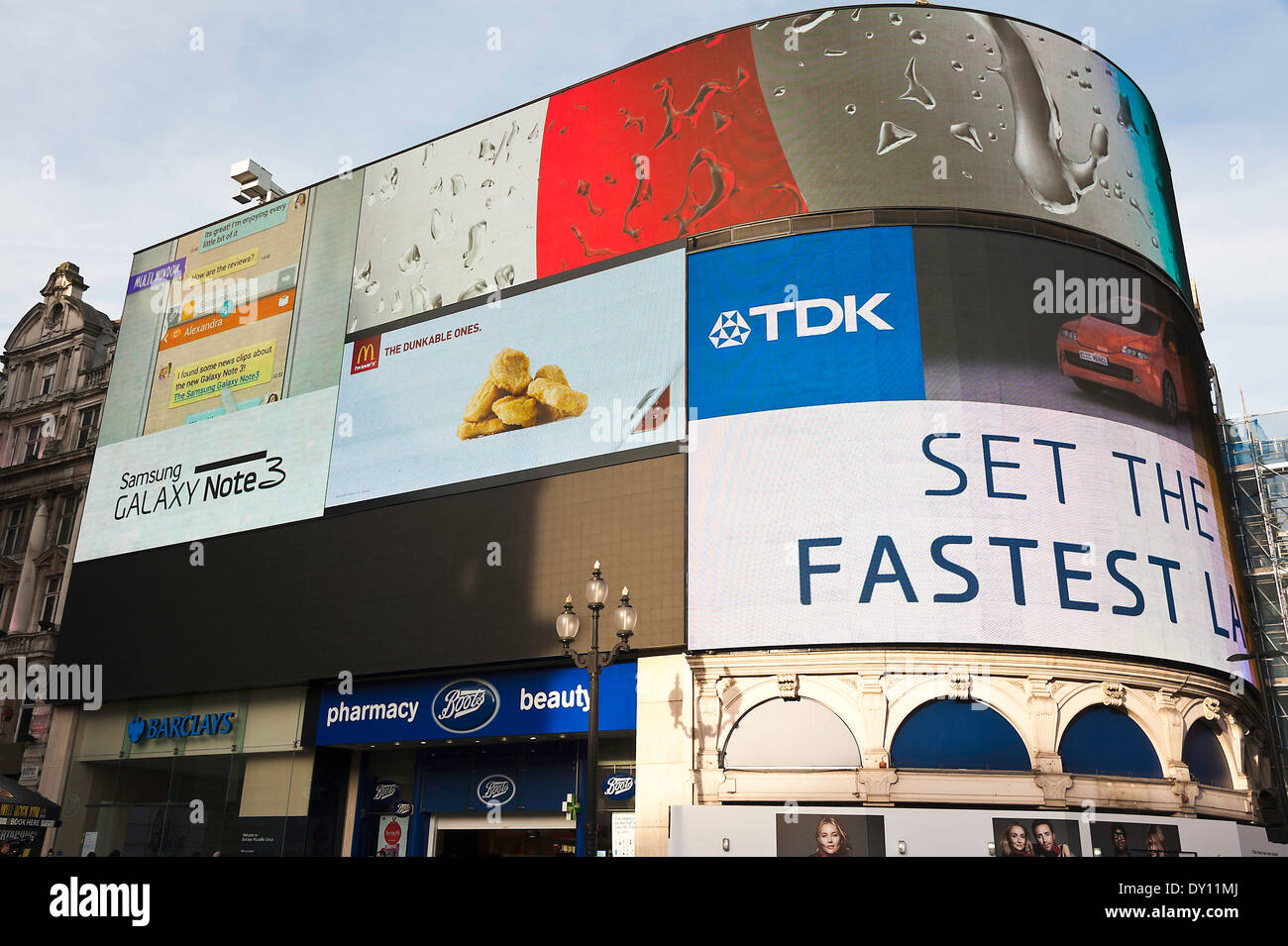 Illuminated Advertising Hoardings and Screens on a Building on the Corner of Piccadilly Circus and Shaftesbury Avenue London Stock Photo