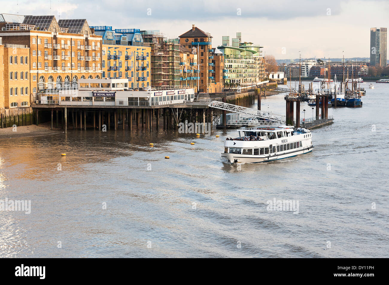 Tourist Boat on River Thames by St Katharine Pier by Tower Bridge City of Westminster London England United Kingdom UK Stock Photo