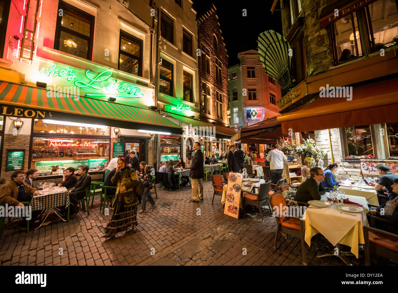 A popular Brussels restaurant specializing in Belgian mussels, Chez Leon on Rue des Bouchers, sits on a narrow cobblestone street along with a street filled with other restaurants popular with tourists. Stock Photo