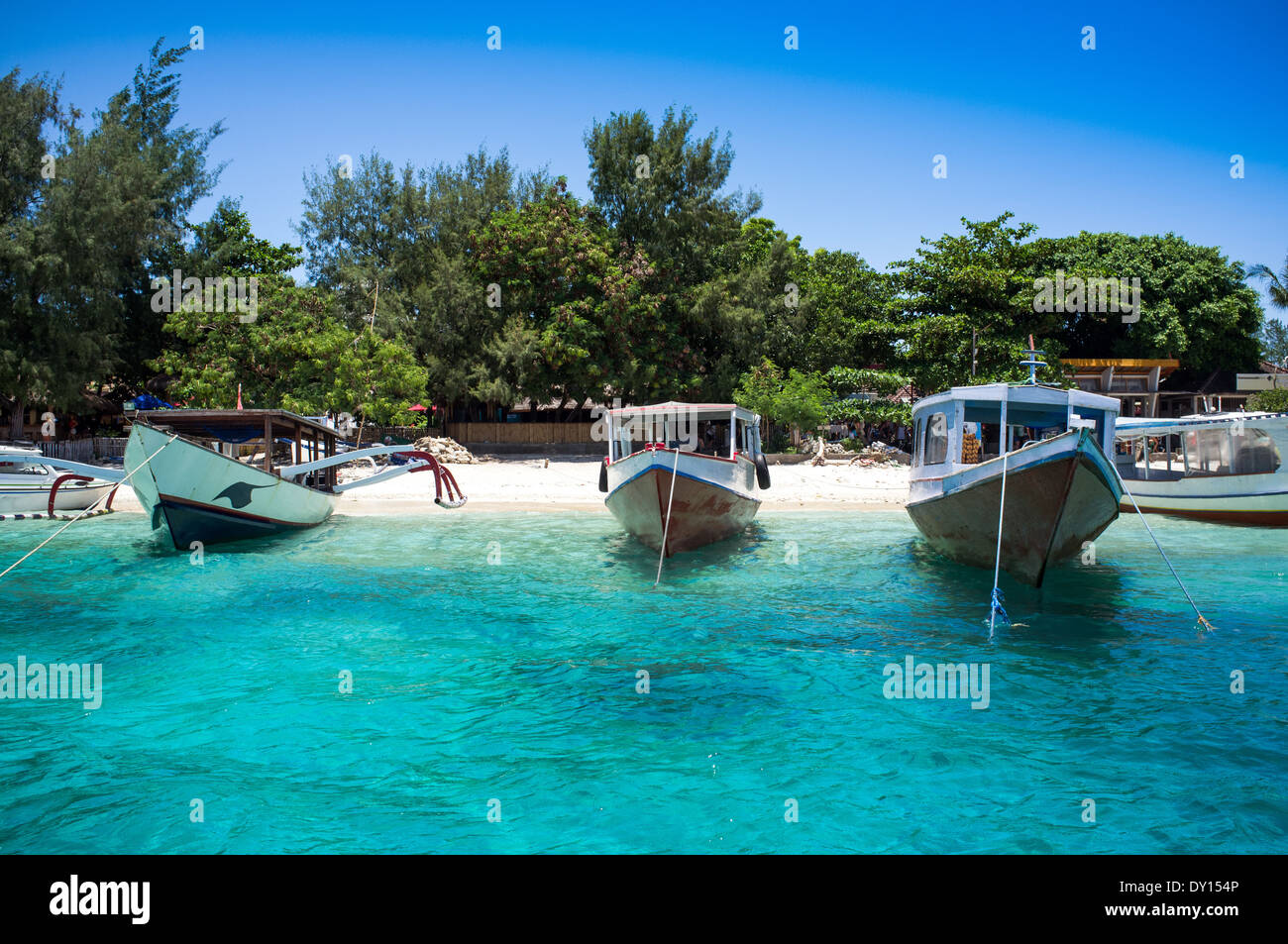 traditional style tourist boat in the shallow waters of gili trawangan lombok indonesia Stock Photo