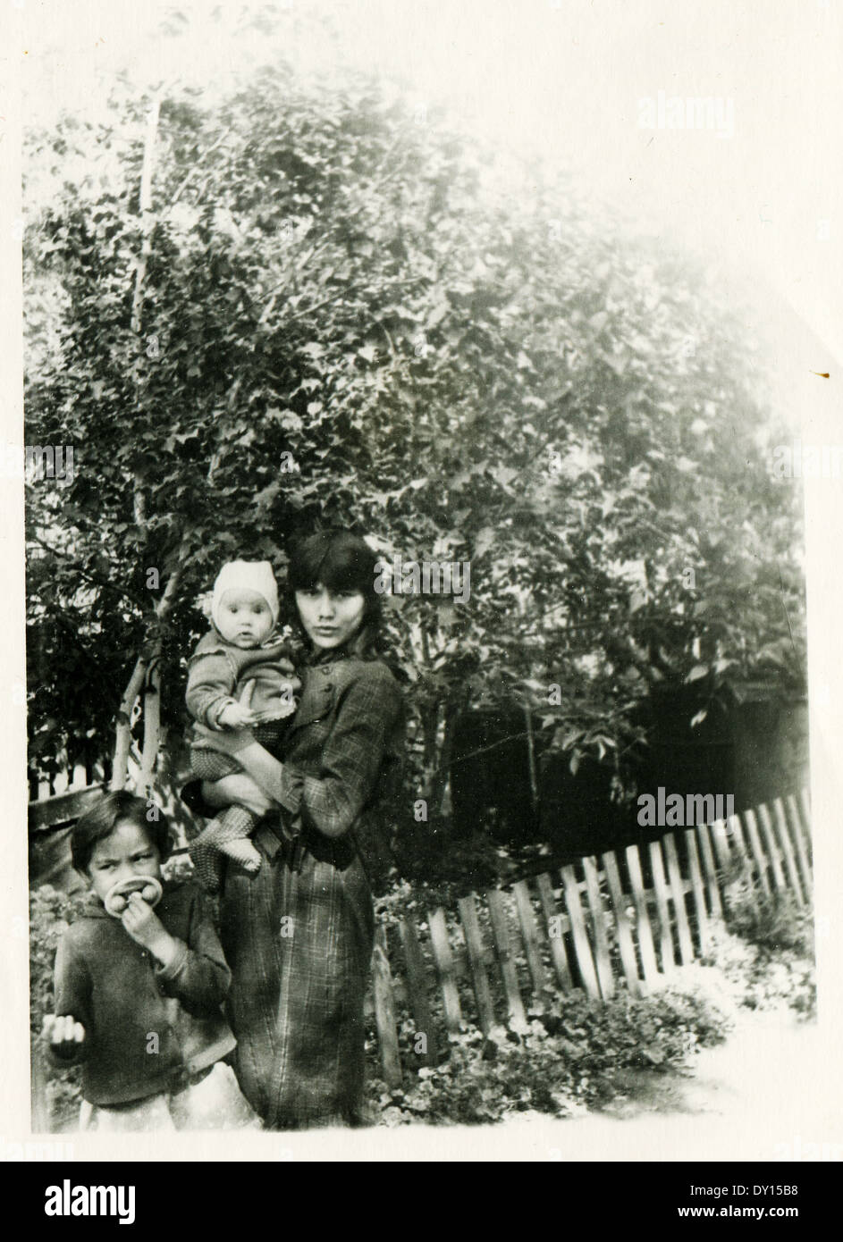 USSR - CIRCA 1980: An antique photo shows woman with two children in garden Stock Photo