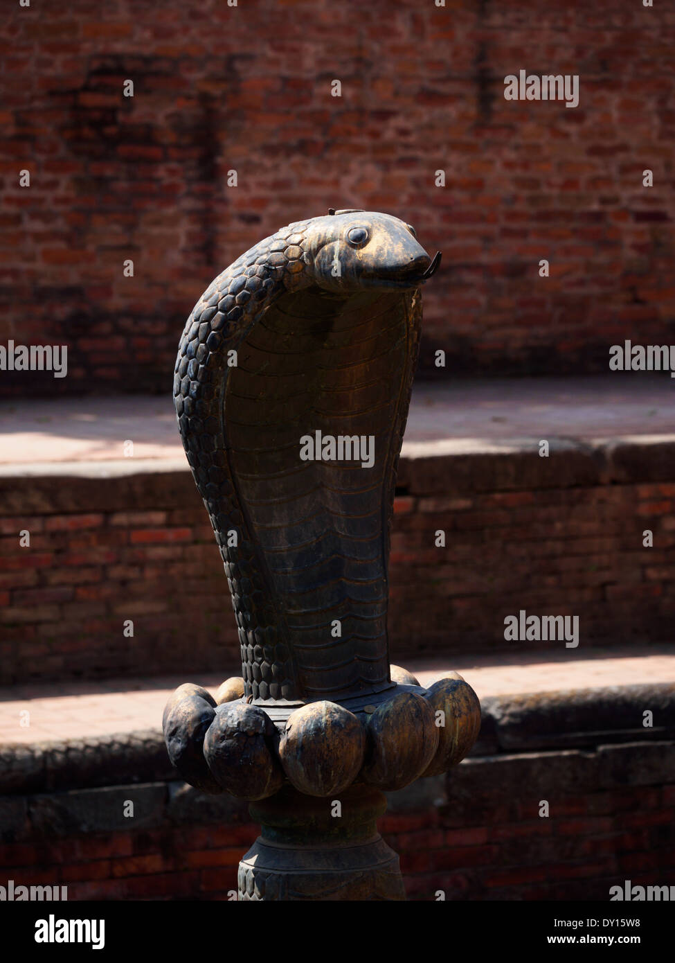 Carved snake head in a courtyard of the former royal palace in Bhaktapur, Nepal Stock Photo