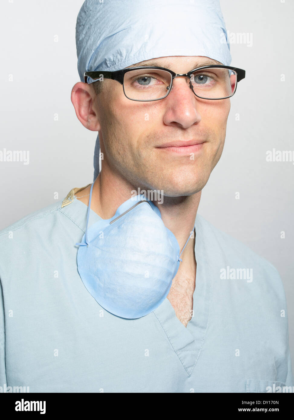 Handsome male medic wearing medical scrubs and glasses. Doctor / Surgeon / Nurse Stock Photo