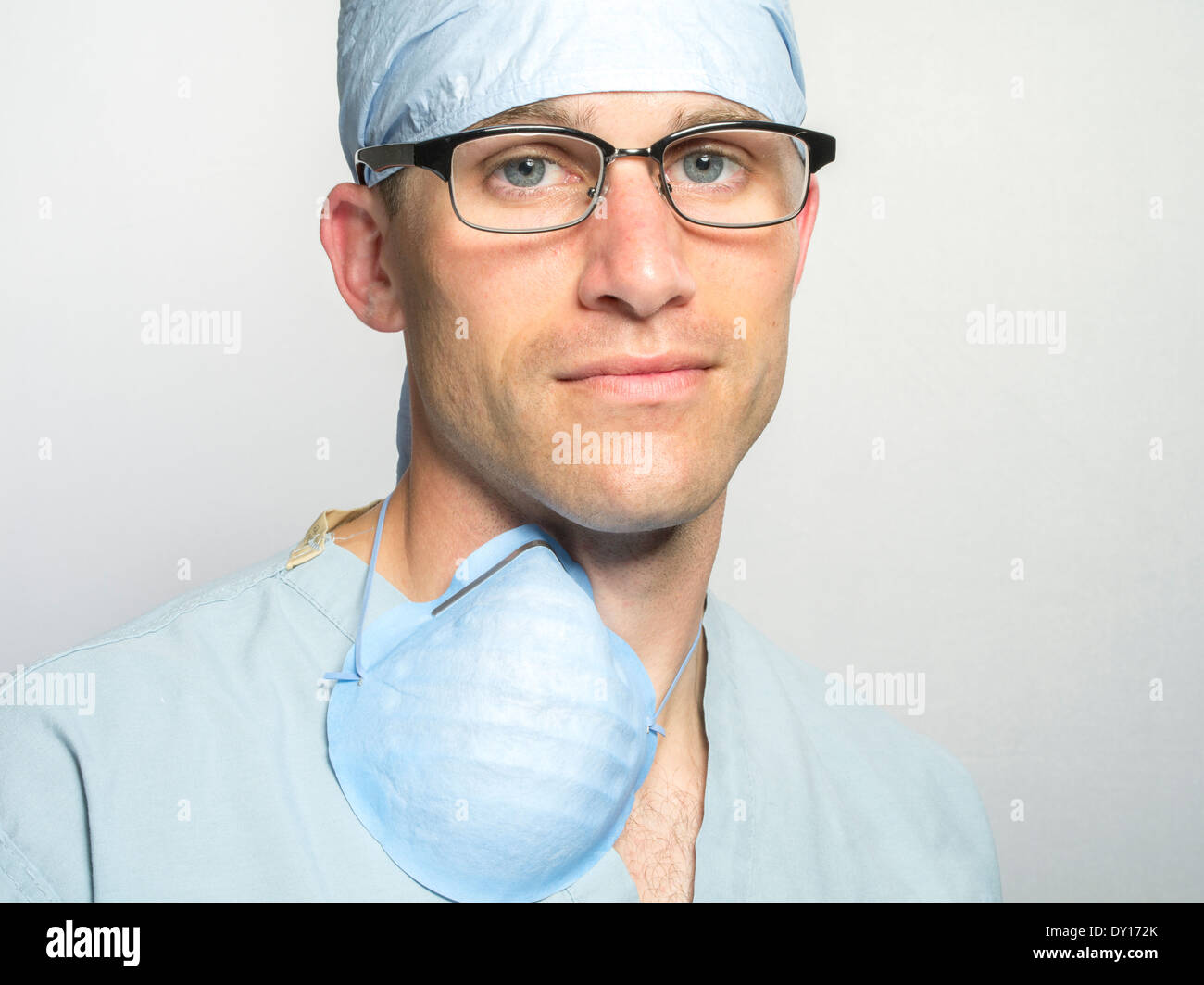 Handsome male medic wearing medical scrubs and glasses. Doctor / Surgeon / Nurse Stock Photo