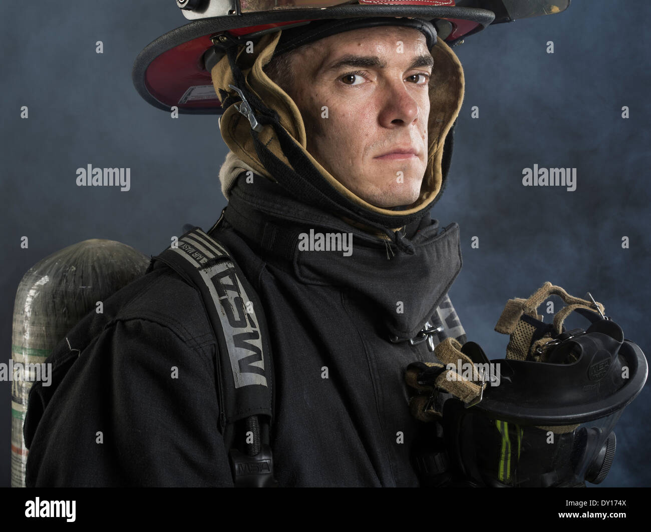 Male firefighter in structural firefighting uniform with breathing