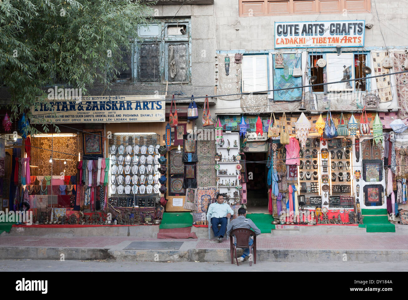 Leh, Ladakh, India. The main bazaar, arts and crafts shops, shopkeepers sitting outside their stores Stock Photo
