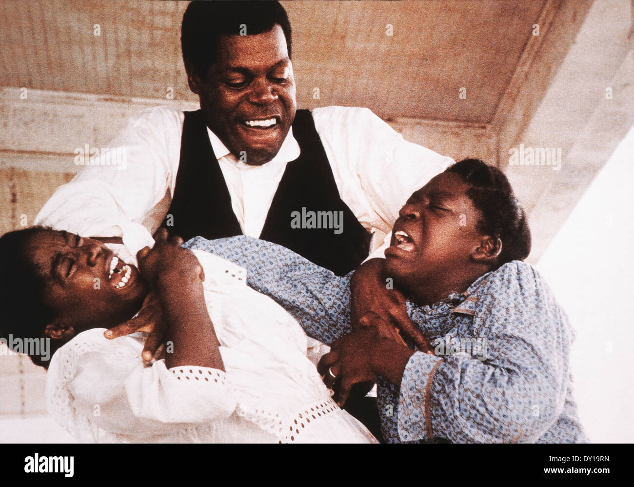 Whoopi Goldberg, Danny Glover and Akosua Busia, on-set of the Film, 'The Color Purple', 1985 Stock Photo