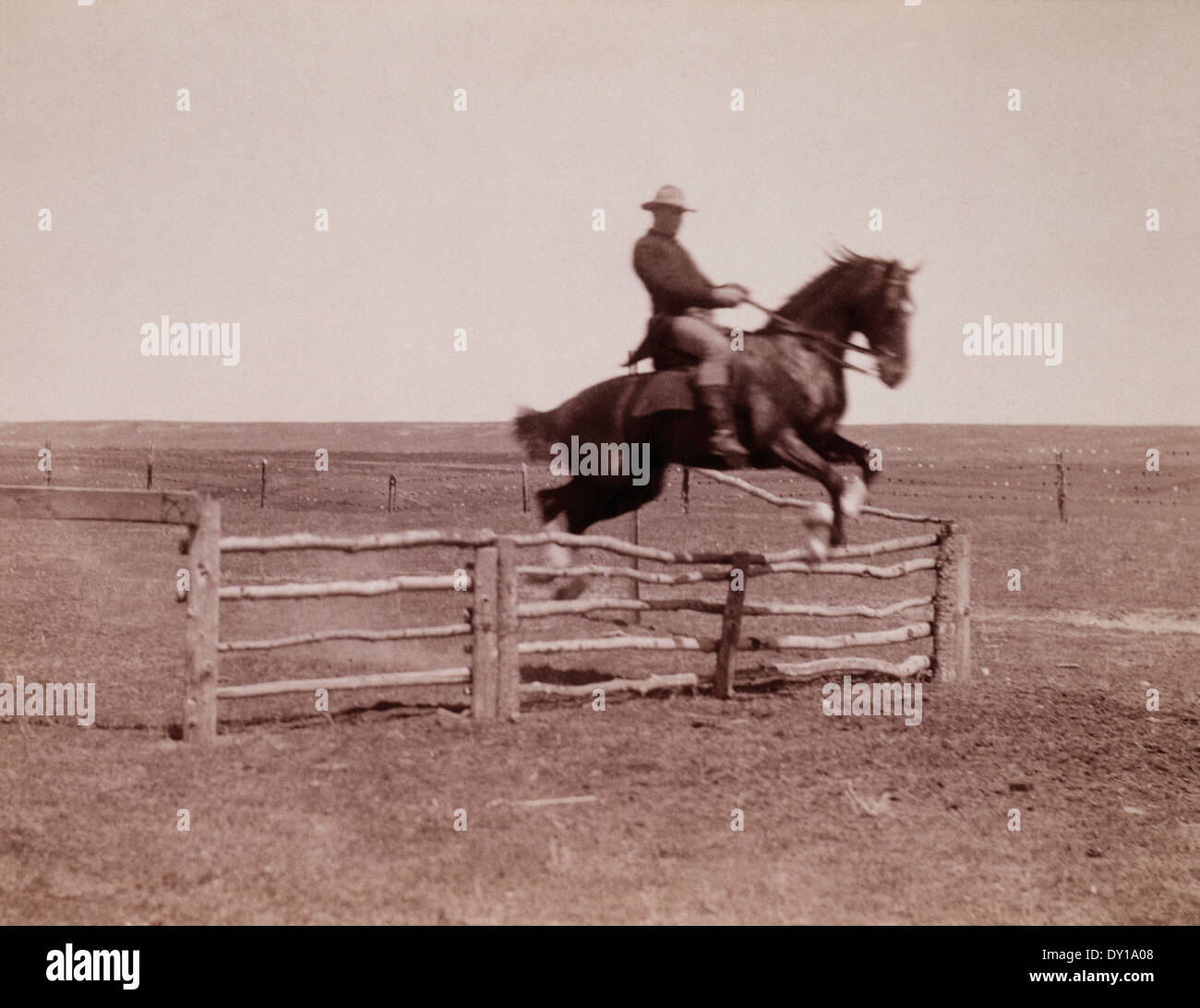 Horse and Rider Jumping Corral Fence, circa 1910 Stock Photo