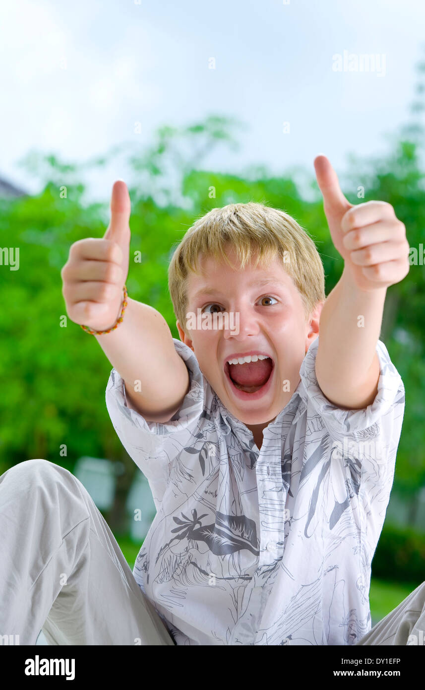 Portrait of young boy giving his thumbs up Stock Photo - Alamy