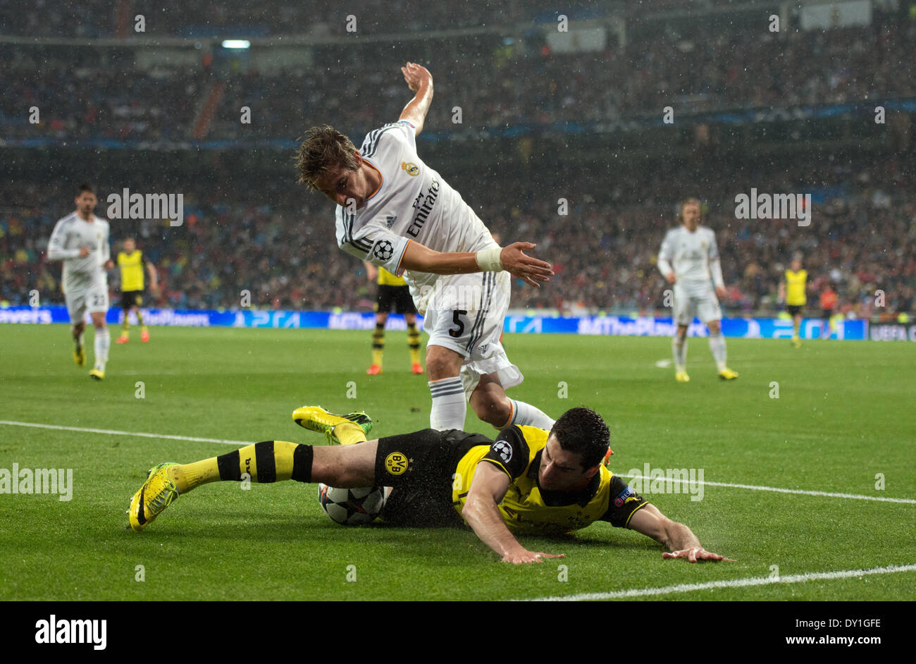 Madrid, Spain. 02nd Apr, 2014. Henrikh Mkhitaryan (FRONT) of Dortmund and Real Madrid's Fabio Coentrao vie for the ball during the UEFA Champions League quarter final first leg soccer match between Real Madrid and Borussia Dortmund at Santiago Bernabeu stadium in Madrid, Spain, 02 April 2014. Photo: Bernd Thissen/dpa/Alamy Live News Stock Photo