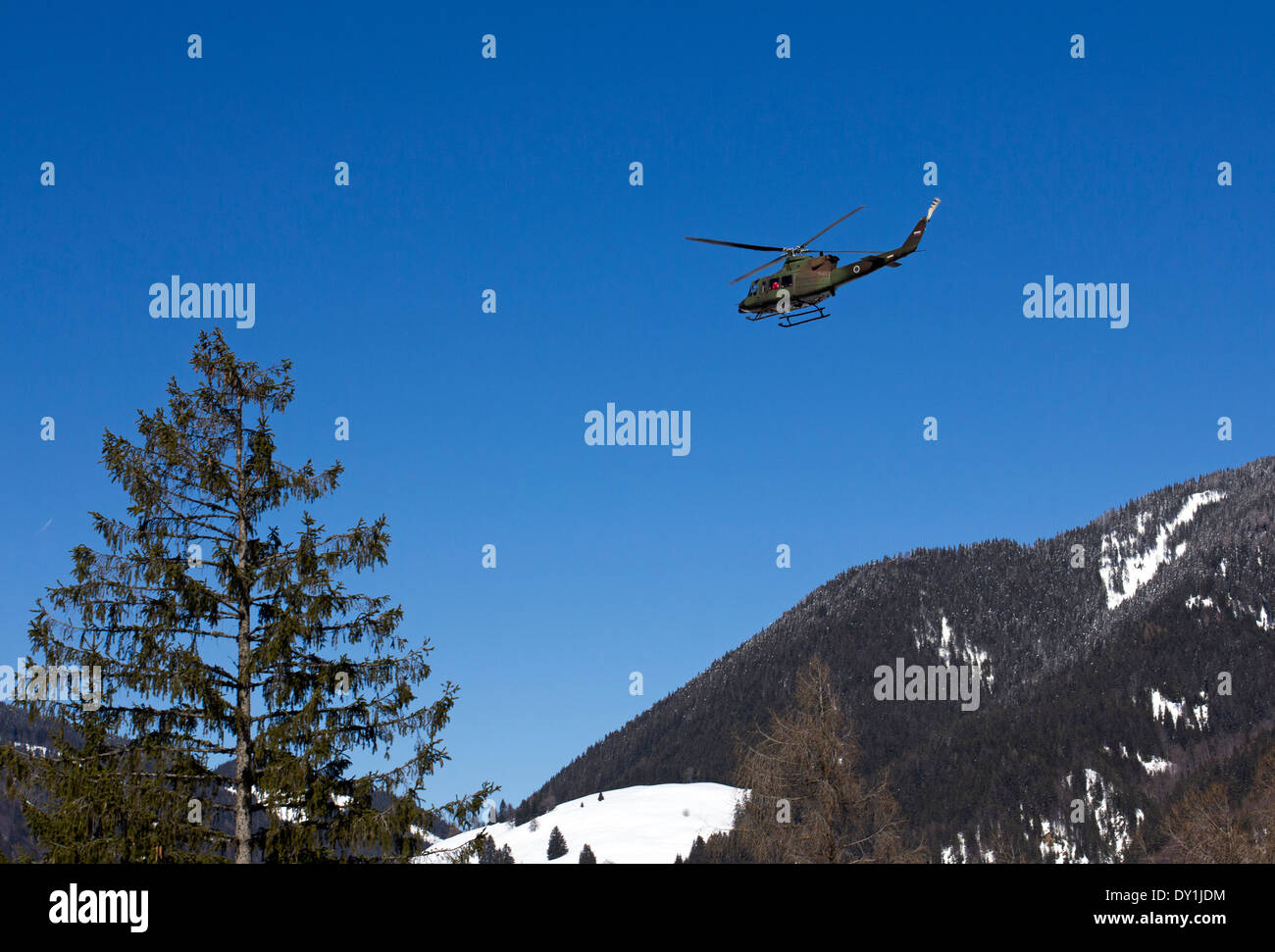 Military helicopter in flight over the Alps in Slovenia Stock Photo