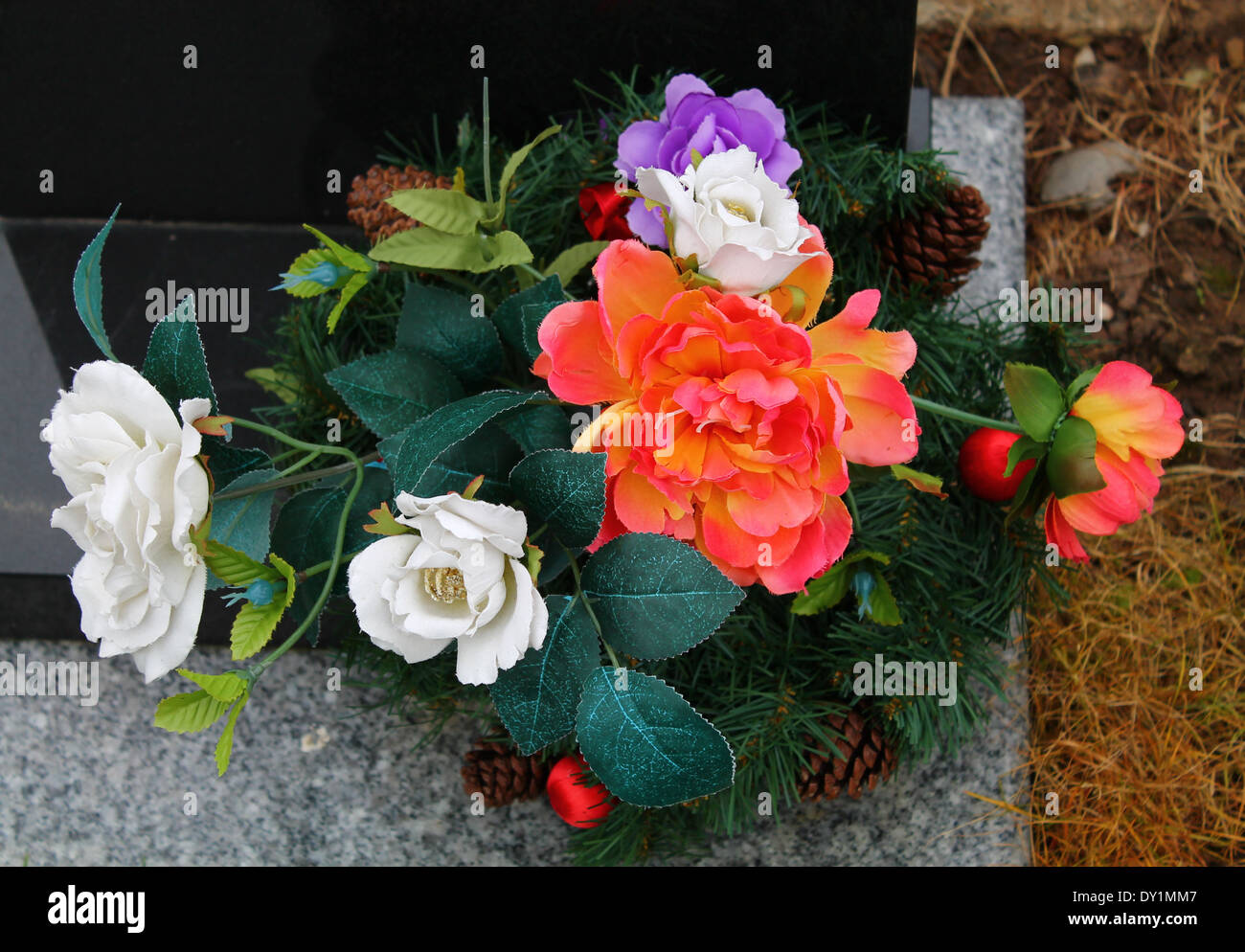 flowers display flower gravestone red leaves rose roses Stock Photo