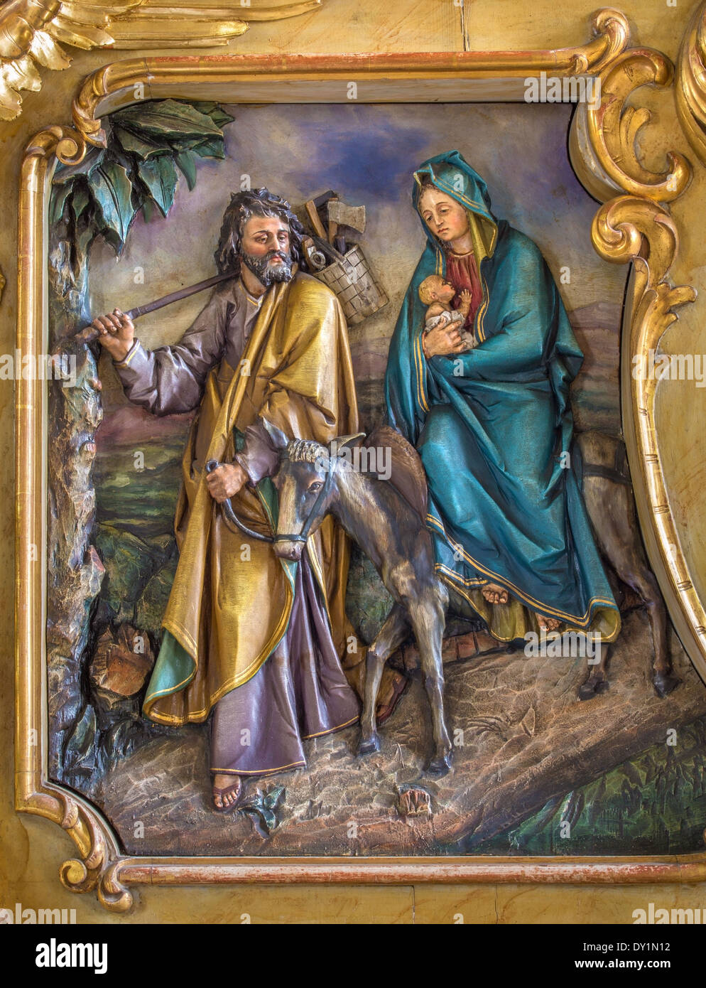 TRNAVA, SLOVAKIA - MARCH 3, 2014: Carved relief of Flight to Egypt scene from side altar of st. Joseph in Jesuits church Stock Photo