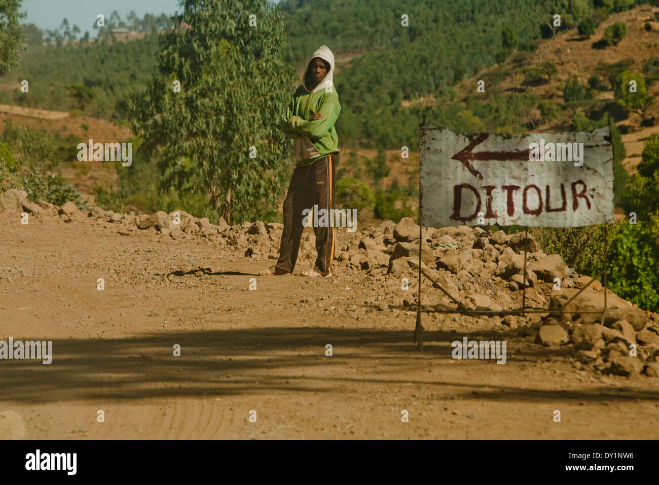 African Ethiopian man Next to ditour sign Detour Stock Photo