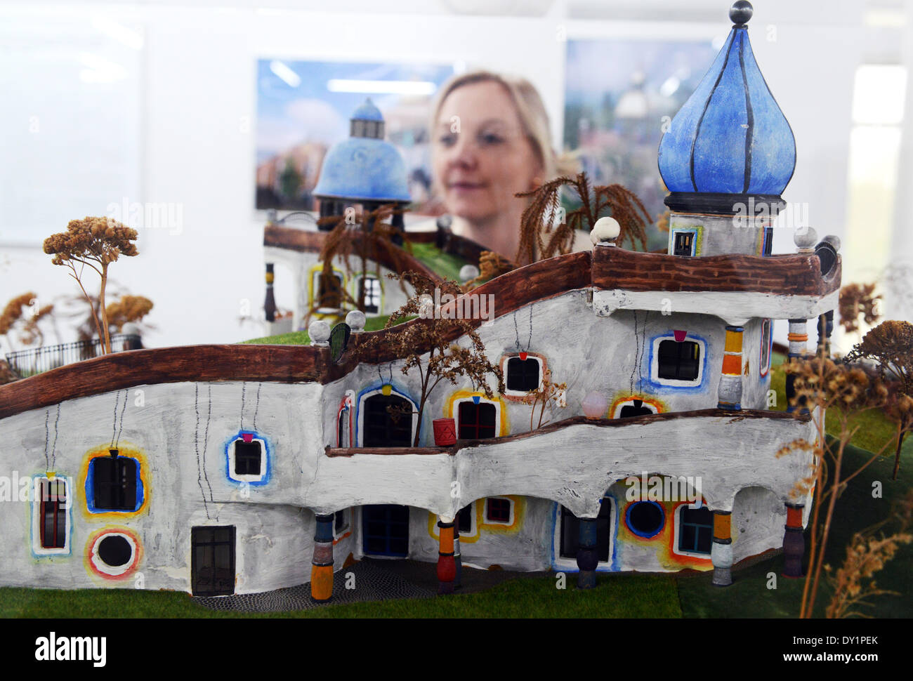 Riegel, Germany. 03rd Apr, 2014. A woman stands in front of the model daycare center Heddernheim by Austrian artist Friedensreich Hundertwasser at Kunsthalle Messmer in Riegel, Germany, 03 April 2014. At the center hangs the large painting 'Adam Kadmon'. The exhibition 'Hundertwasser and Ernst Fuchs' runs from 05 April to 14 September 2014. Photo: Patrick Seeger/dpa/Alamy Live News Stock Photo