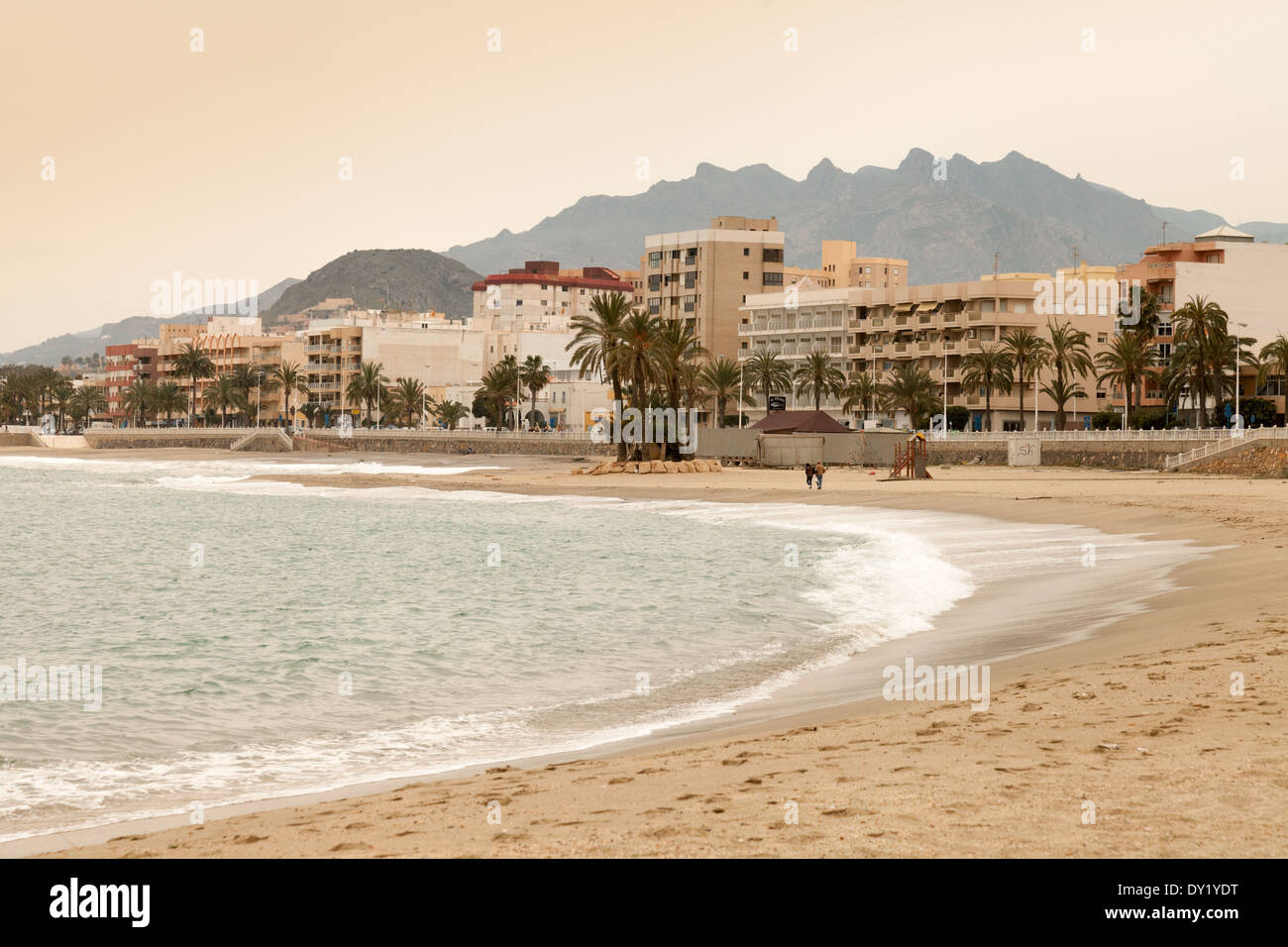 People walking on the beach in the distance in the evening, Garrucha, Almeria Andalusia Spain Europe Stock Photo