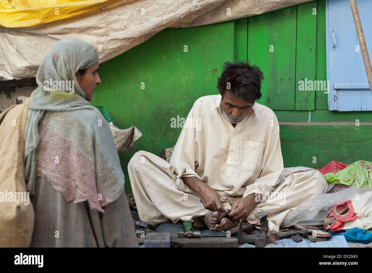 Srinagar, Kashmir, India, South Asia. Cobbler, repairing shoes in the