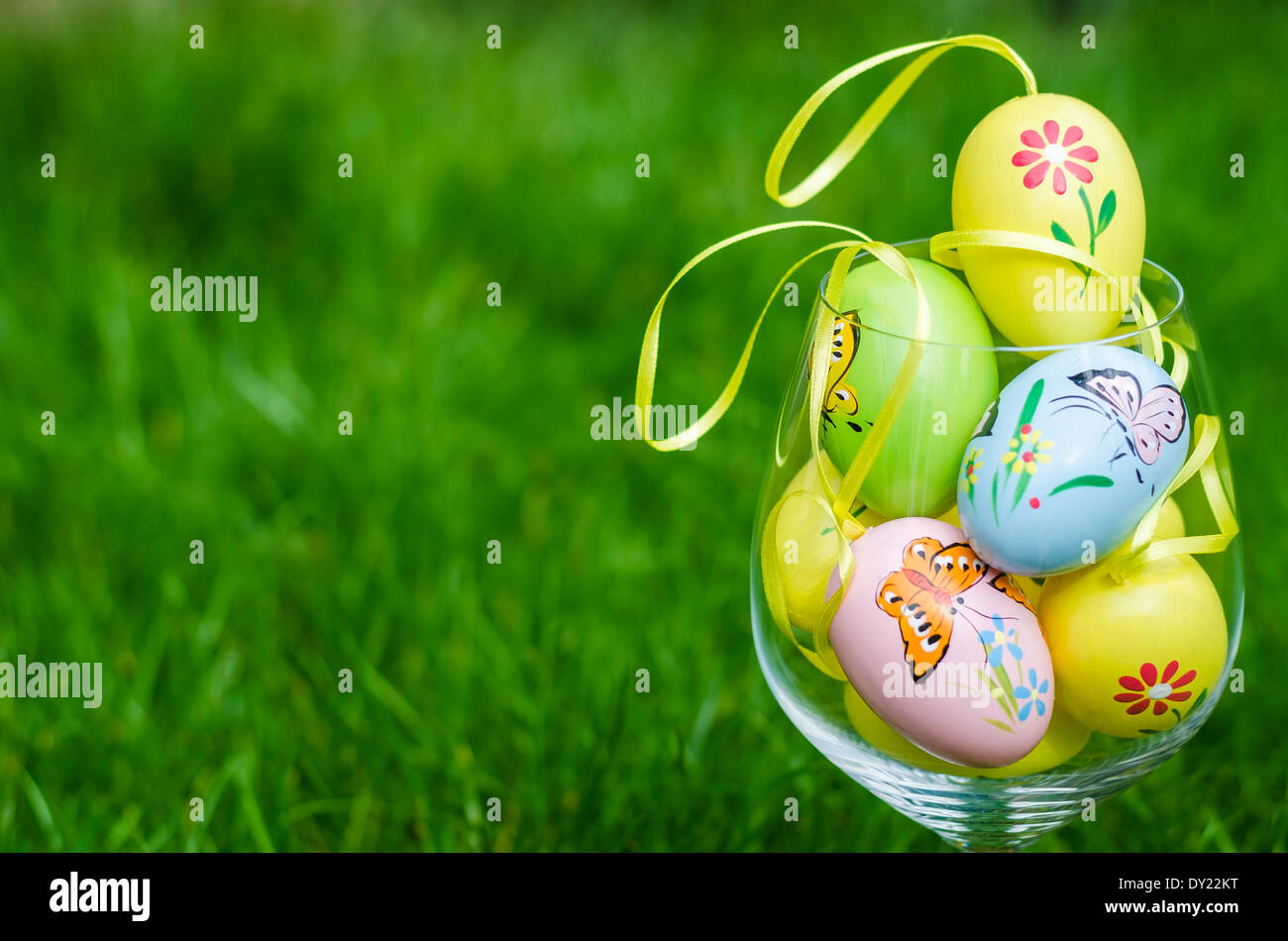 Painted easter eggs in a glass on a fresh green grass Stock Photo - Alamy