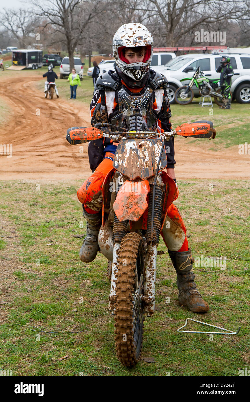 Muddy Motocross Rider Exhausted after Race Stock Photo