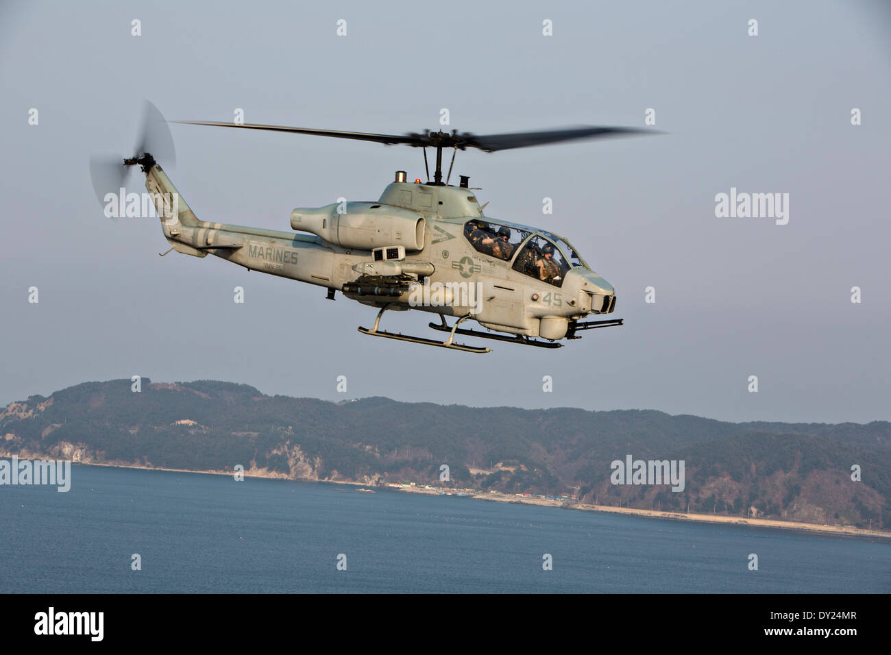 A US Marine Corps AH-1W Cobra helicopter provides close air support during exercise Ssang Yong April 1, 2014 off the coast of Doksu-Ri, Pohang, South Korea. Stock Photo