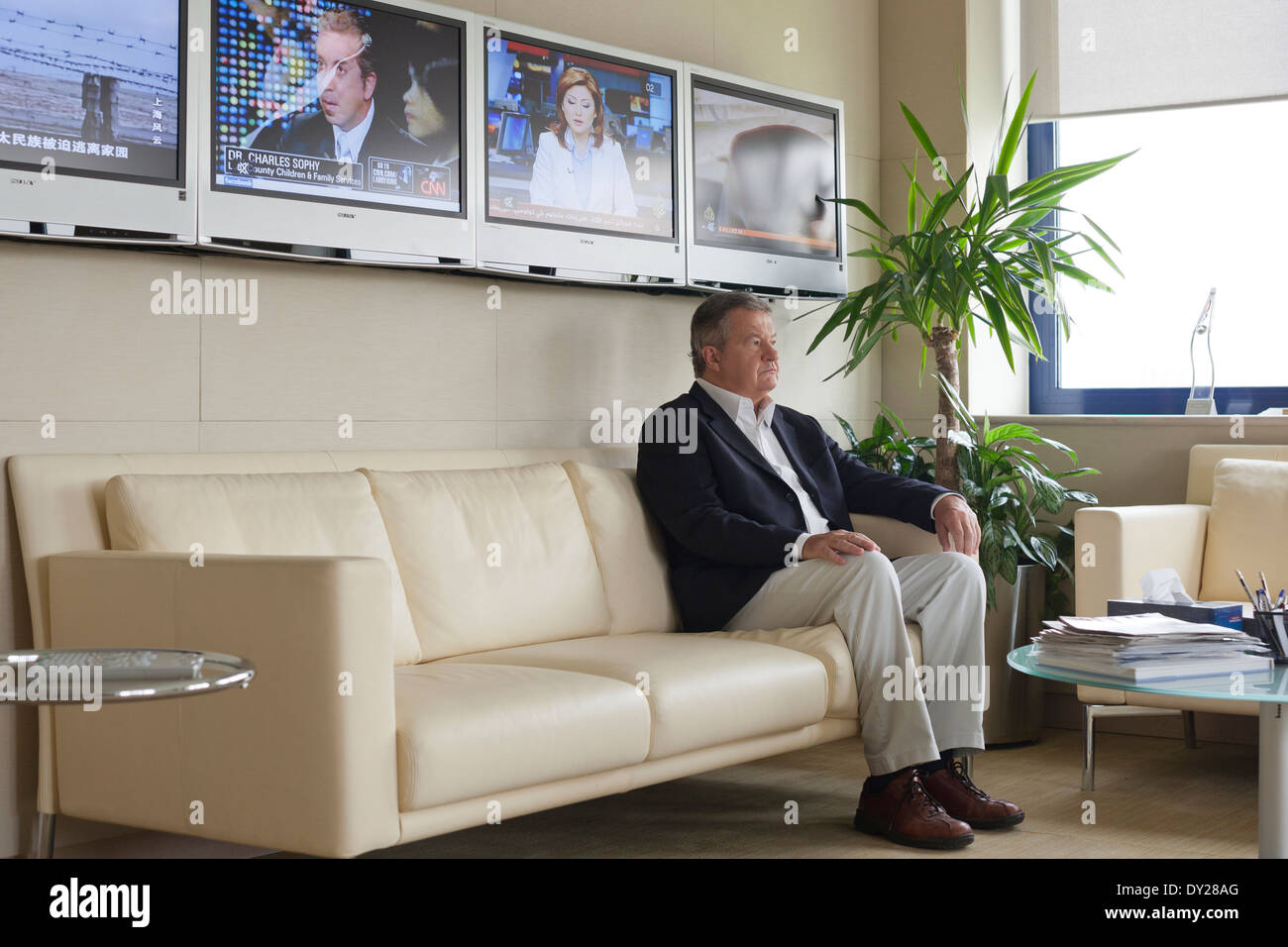 Tony Burman, Managing Director of Al Jazeera English (2008 - 2010) sits for a portrait in his office in Doha, Qatar. Stock Photo