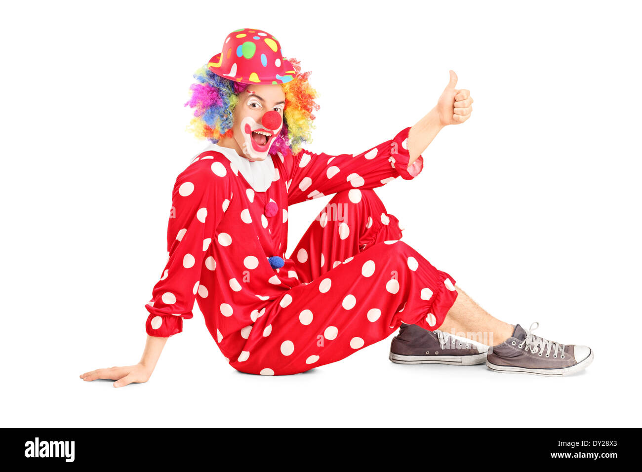 Clown sitting on the floor and giving thumb up Stock Photo