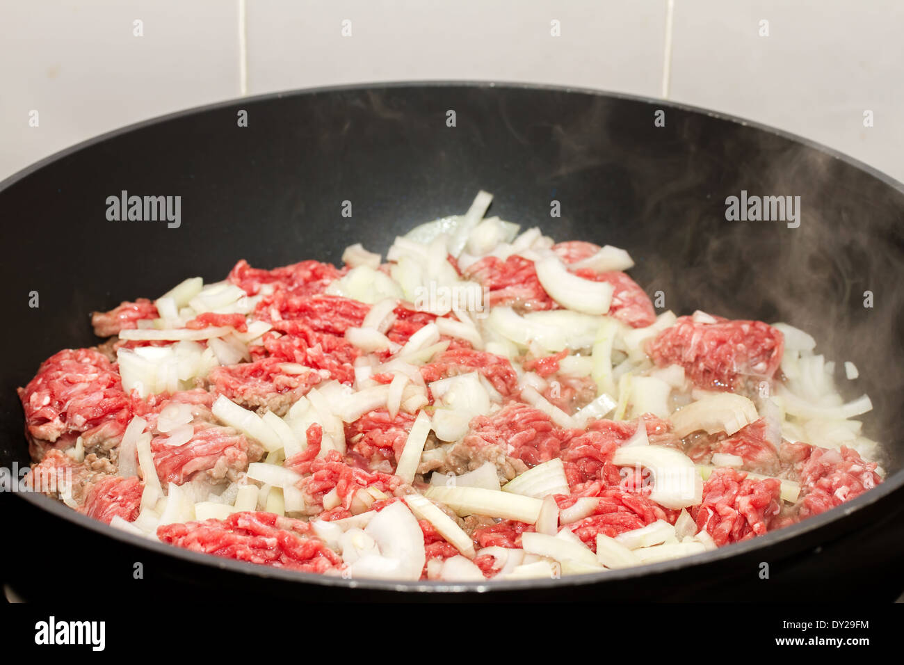 Ground beef with onions browning in a pan Stock Photo Alamy