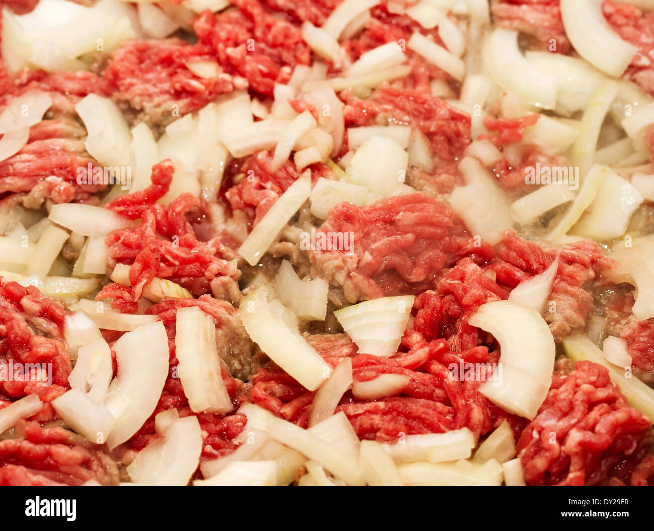 Ground beef and onions browning in a pan Stock Photo Alamy