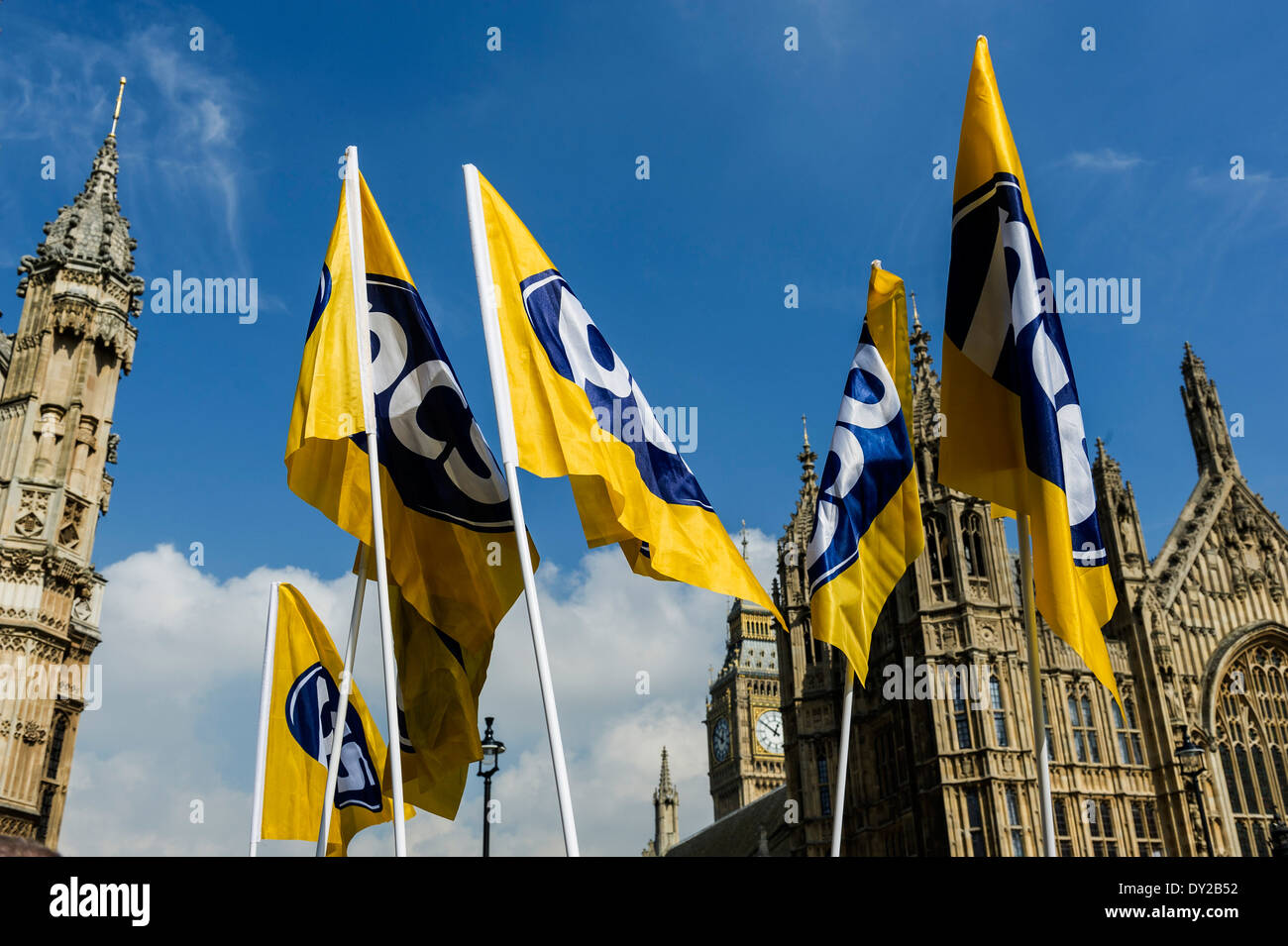 Flags of the PCS trade union being flown at a demonstration outside the Houses of Parliament. Stock Photo