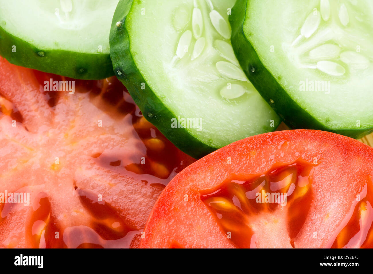 Vegetables background. Fresh slices of cucumber and tomato Stock Photo ...