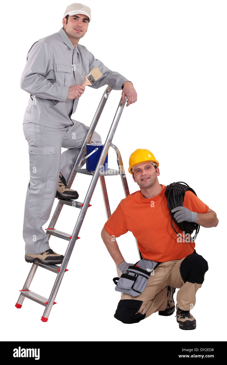 Painter on a ladder and crouching electrician Stock Photo Alamy