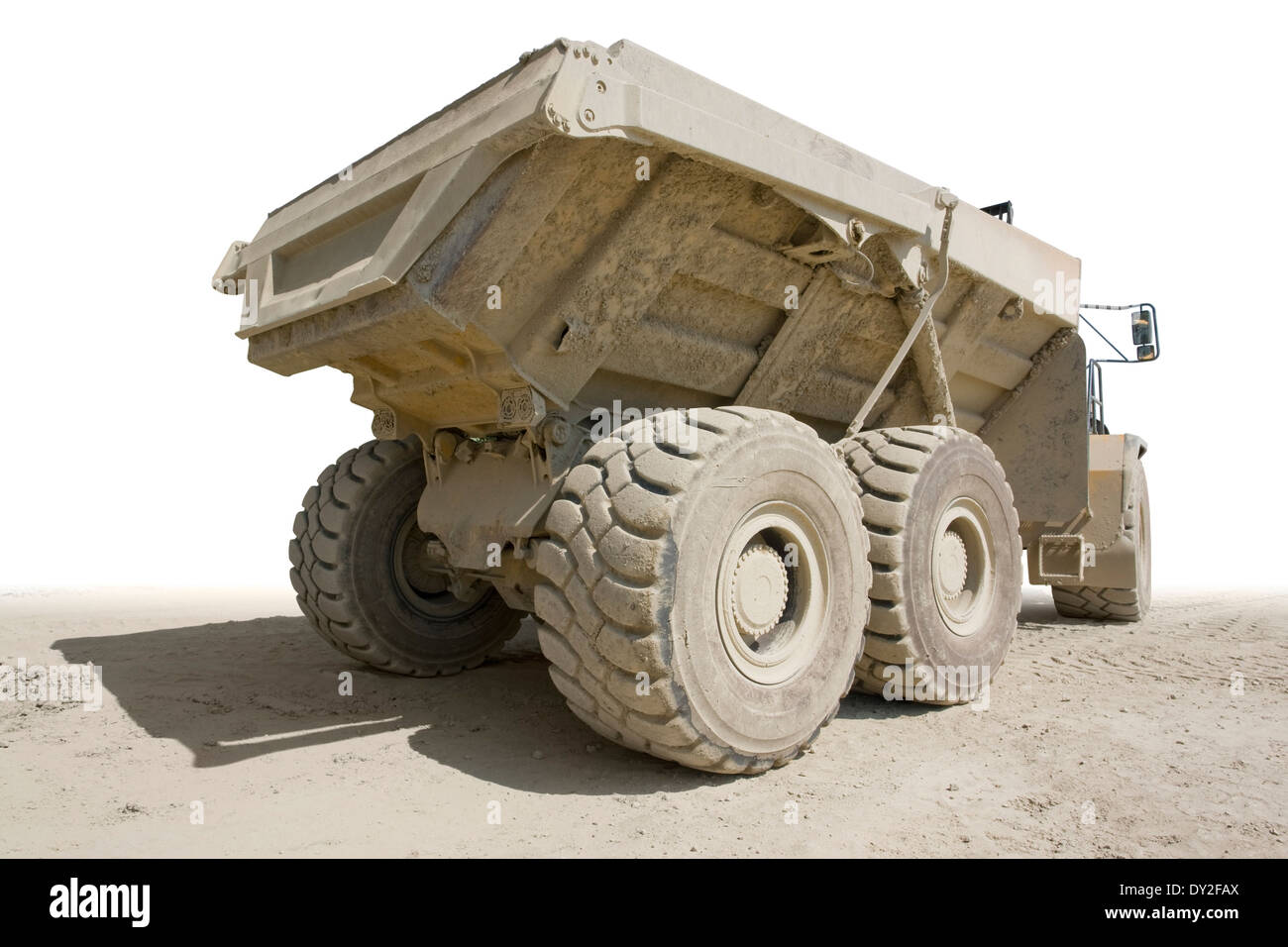 back side of a dirty dumper in sunny ambiance, partly isolated in white back Stock Photo