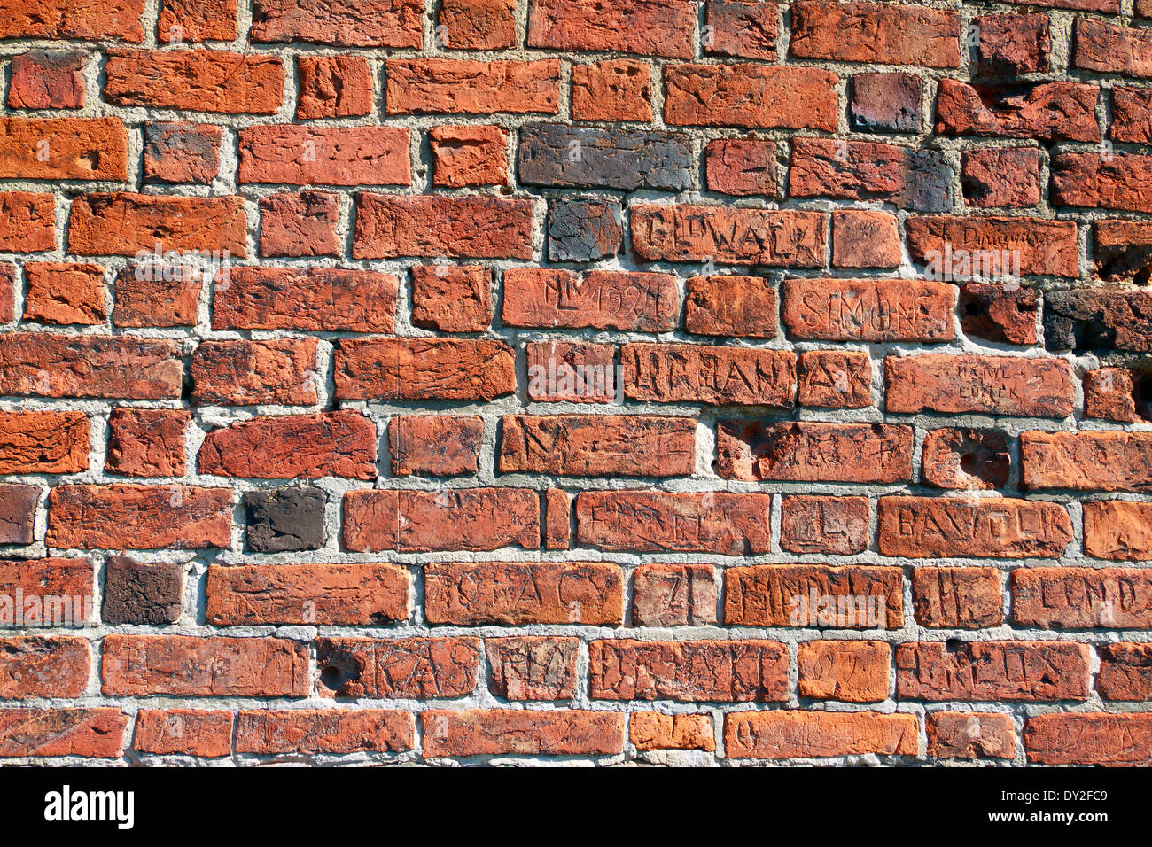 Brick wall inscriptions, words and letters Stock Photo