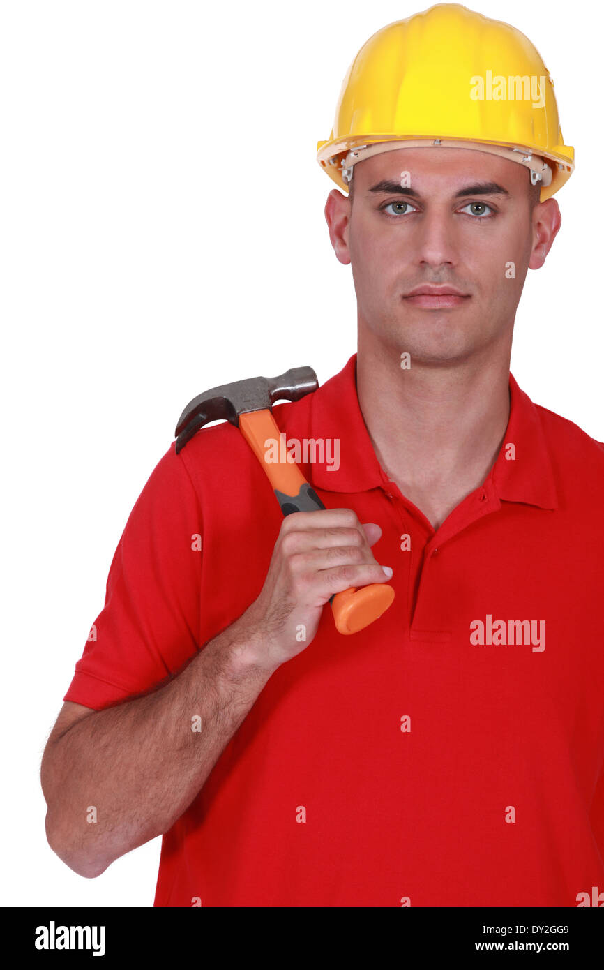 Serious handyman holding hammer Stock Photo Alamy