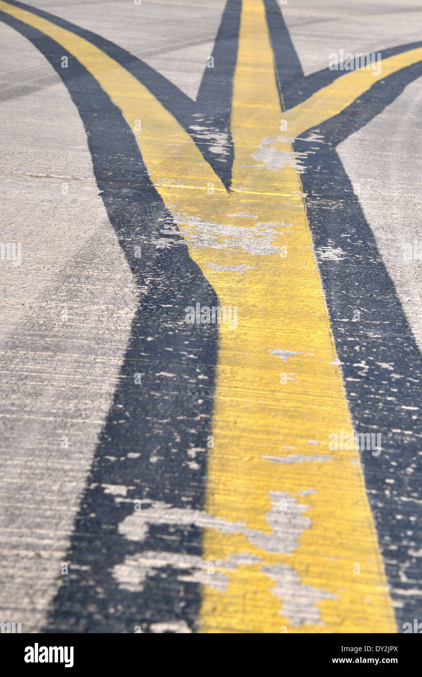 Worn Road markings on an airplane runway Stock Photo