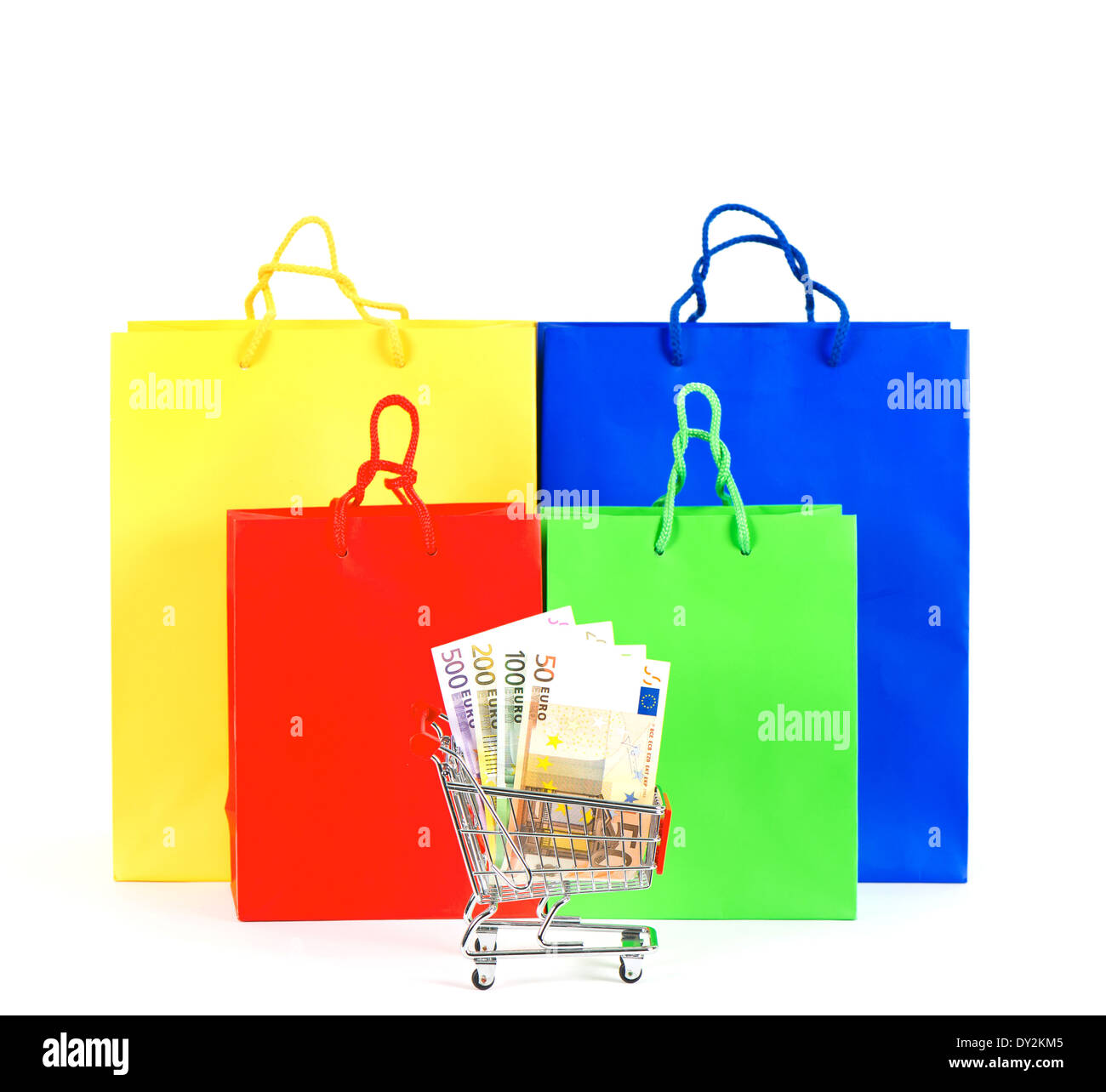 colorful bags and cart with cash notes. shopping concept Stock Photo