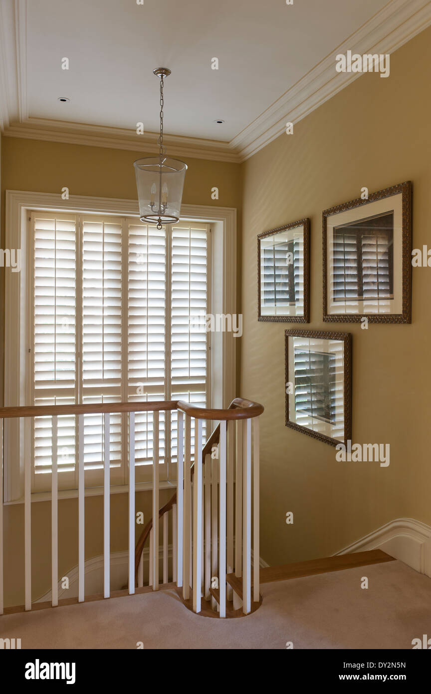 Glass lantern on staircase landing with banister and window blinds Stock  Photo - Alamy