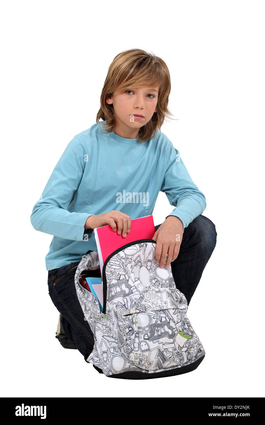 Boy packing school bag Stock Photo